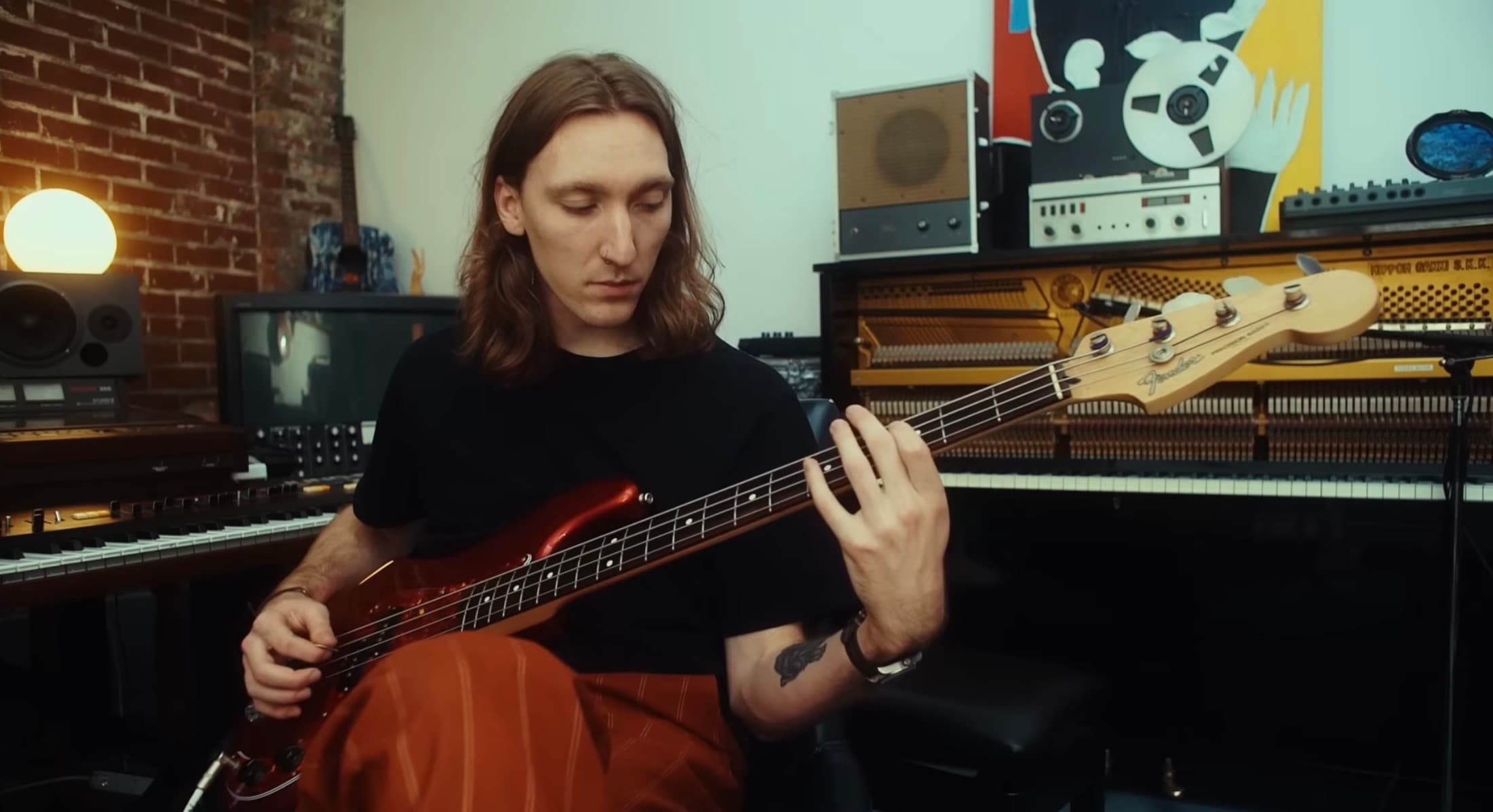 Kaden Smith playing bass in the studio.